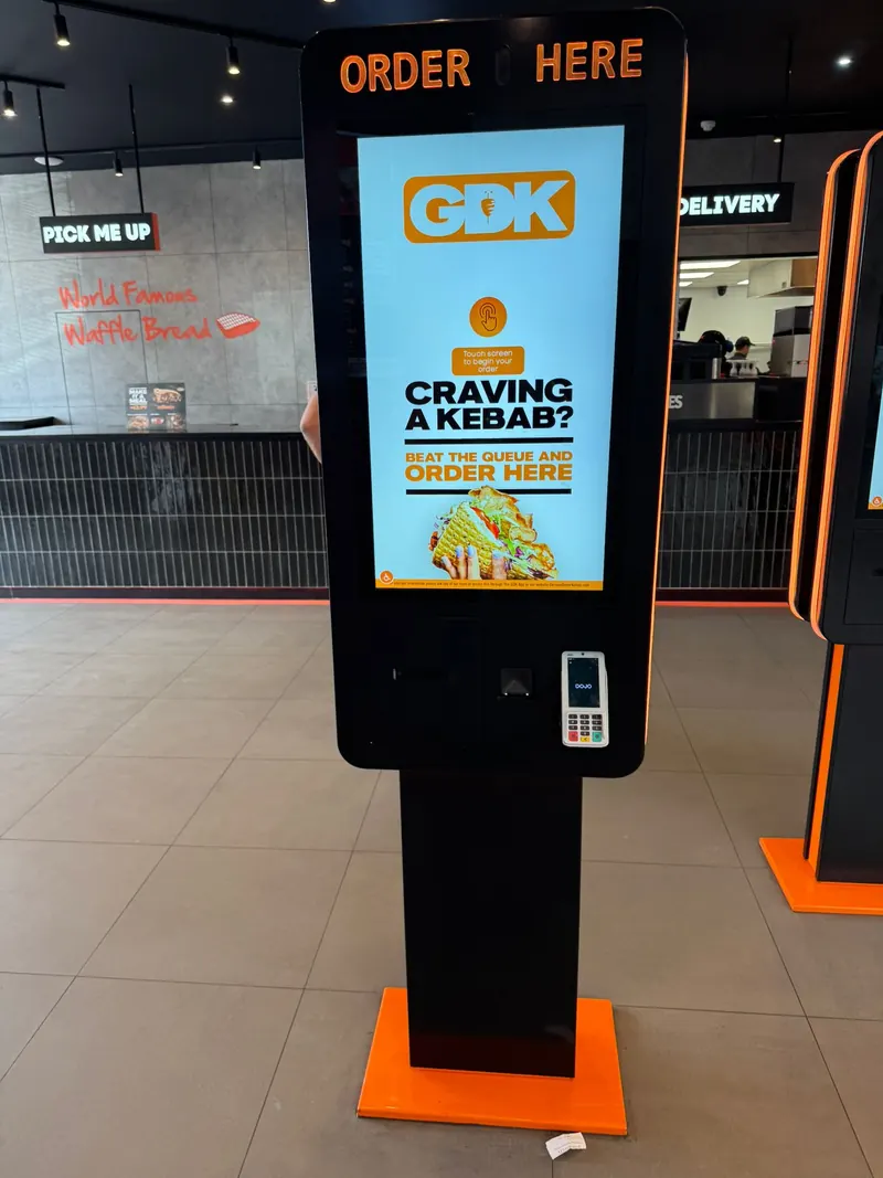 A self-order kiosk standing in a restaurant
